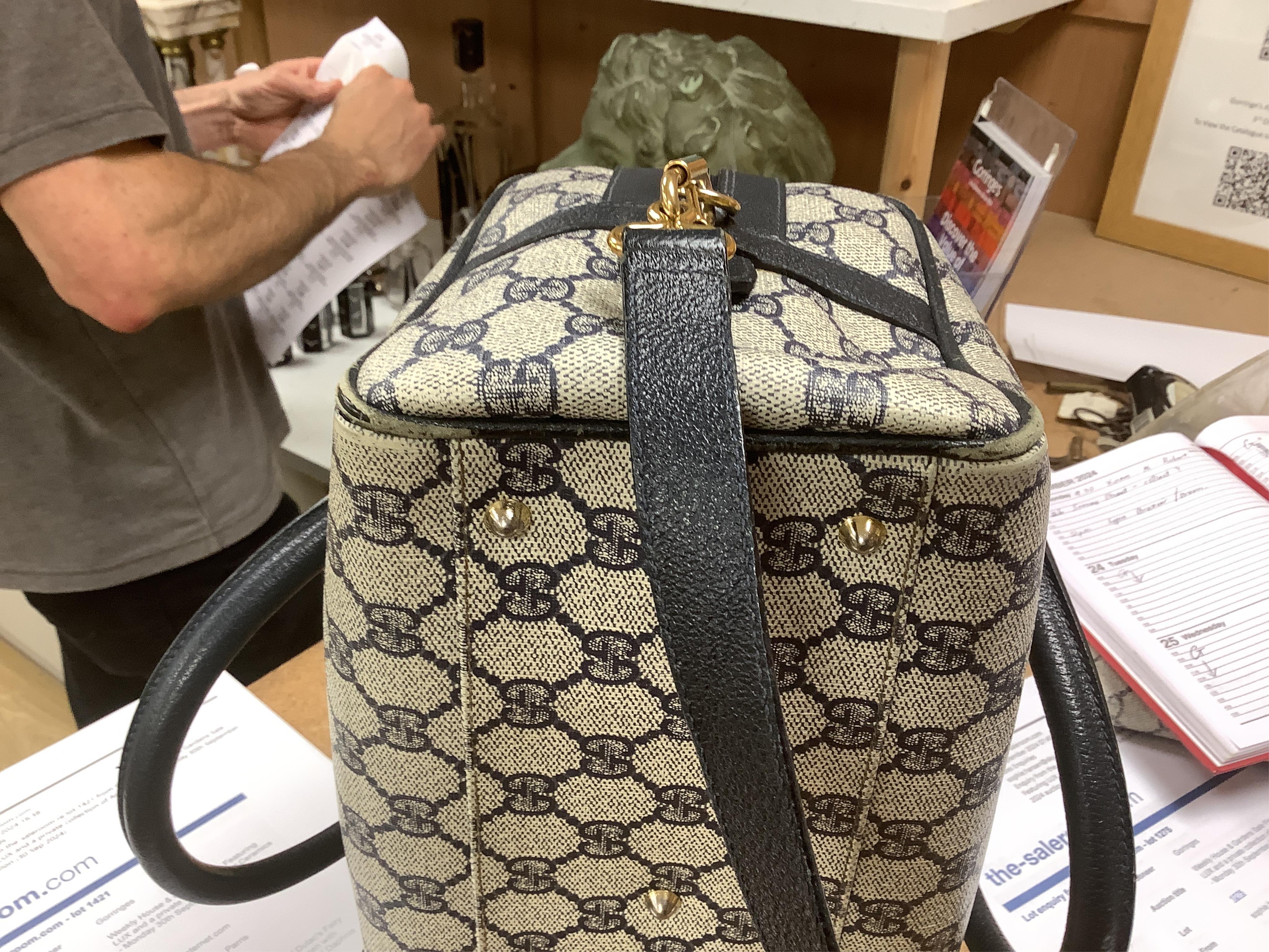 A Gucci monogram blue canvas handbag, wallet and purse